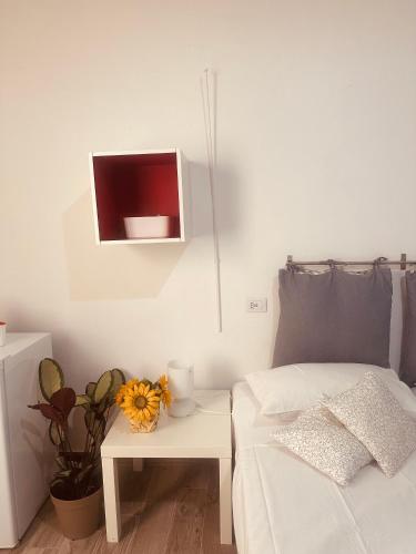 a bedroom with a bed and a table with a tv at Corte Perugia in Matino
