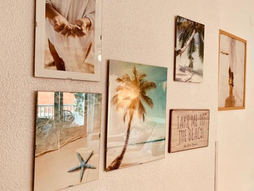 a wall with pictures of a palm tree on it at Mar De Cristal apartment 100 metres to the beach in Cartagena