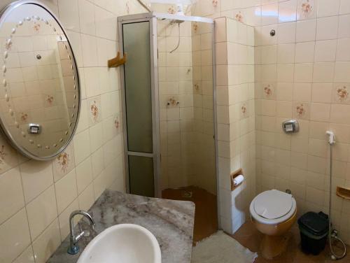 a bathroom with a shower and a sink and a toilet at HOTEL TRES LAGOAS in Três Lagoas