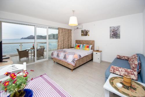 a bedroom with a bed and a view of the ocean at Apartments AriaSana in Dobra Voda