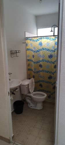 a bathroom with a toilet and a sink at Casa Latania in El Salto
