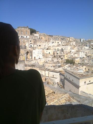 a person looking out at a city from a building at Alla dimora di Chiara Suite and Rooms in Matera