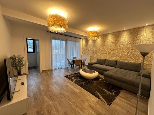 sala de estar con sofá y mesa en The View Apartment Bușteni, en Buşteni