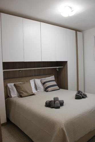 a bedroom with a large bed with two stuffed animals on it at Villa CasArte in Bari