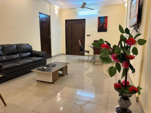 a living room with a couch and a coffee table at MYKONOS in Ouagadougou