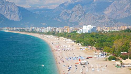 a beach with a bunch of people and the water at Beyond OTEL in Antalya