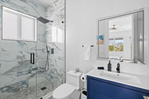a bathroom with a toilet and a sink and a shower at Luna Light ~ Waterfront ~ Pool ~ Dock ~ Views in Marathon