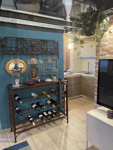 a room with a shelf of wine bottles at Crystal Loft Luxury Milano in Milan