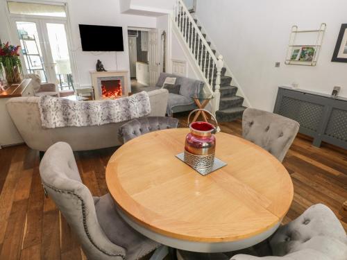 a living room with a wooden table and chairs at 5 Pontardulais Road in Llanelli