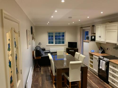 a kitchen and dining room with a table and chairs at Valley view in Gort