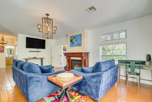 a living room with two blue couches and a fireplace at Decks, Docks and Kayaks Waterfront Homosassa Gem in Homosassa