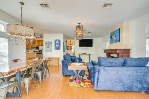 a living room with blue couches and a table at Decks, Docks and Kayaks Waterfront Homosassa Gem in Homosassa