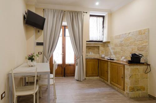 a kitchen with a table and a dining room at Dependance Ludovica in Termoli