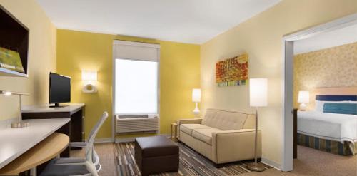 a hotel room with a bed and a desk at Home2 Suites by Hilton Houston Pasadena in Pasadena