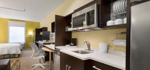 una cocina con fregadero y una cama en una habitación en Home2 Suites by Hilton Houston Pasadena en Pasadena