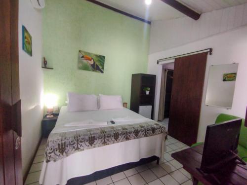 a bedroom with a large bed in a room at Pousada Sonho da Lagoa in Praia do Forte