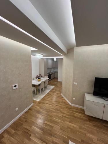 a living room with a table and a television at Apartment Nadaa in Čapljina