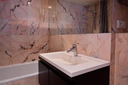 a bathroom with a white sink and a bath tub at Saint-Germain-des-Pr&eacute;s in Paris in Paris