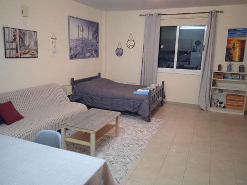a living room with a couch and a bed at Xylophagou Rest and Relax 3 Ayia Napa Larnaca 1 bedroom apartment in Xylophaghou
