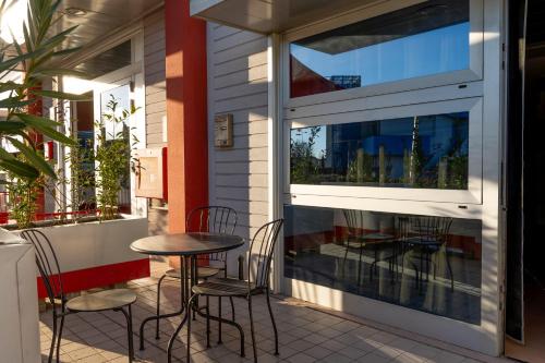 a patio with chairs and a table in front of a window at Easy Space in Bientina