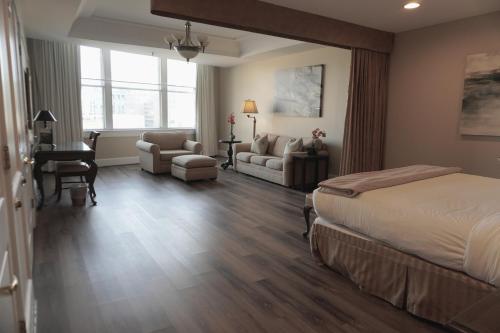a bedroom with a bed and a living room at Haywood Park Hotel, an Ascend Collection Hotel in Asheville