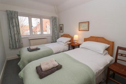 a bedroom with two beds and a window at Eldoret in Aldeburgh