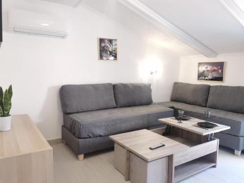 a living room with a couch and a table at Anthis Studios in Pythagoreio