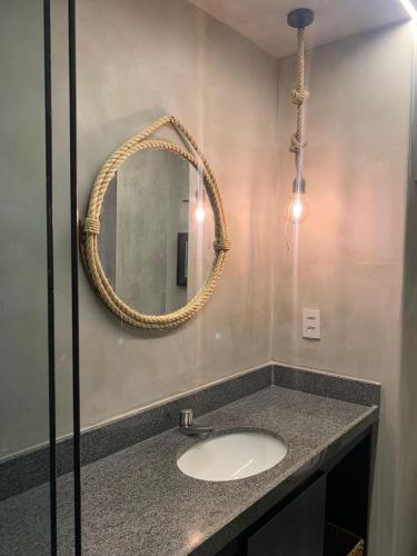 a bathroom with a sink and a mirror at Eco Resort - Praia dos Carneiros - ao lado da Igrejinha in Rio Formoso