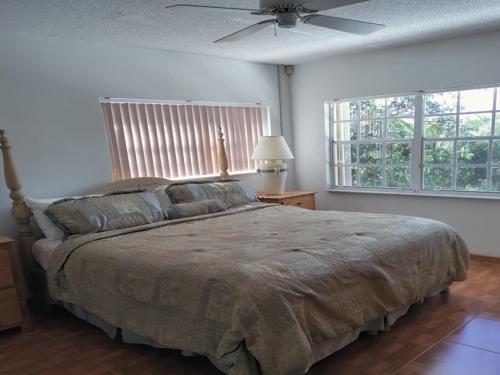 a bedroom with a bed and a ceiling fan at Beach Paradise with Pool and Boating Dock in Freeport