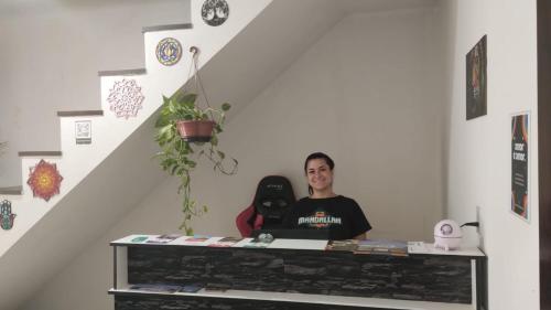 two people sitting at a table in a room at Mandallah Hostel in Joinville
