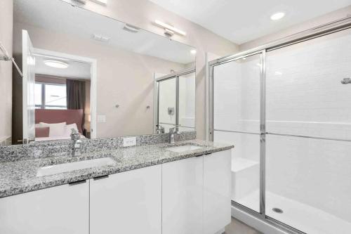 a white bathroom with two sinks and a shower at SUPER CLOSE - DISNEY's PARKs with THEME ROOMs & POOL in Orlando