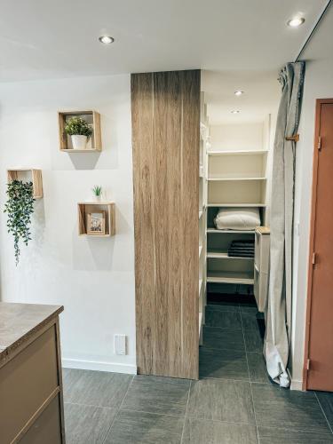 a walk in closet in a kitchen with white walls at BEACH HOUSE 100M PLAGE, SUR LE PORT. in Frontignan