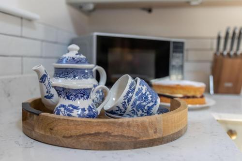 a bowl filled with blue and white china on a counter at The Hay Loft by Big Skies Cottages in Swafield