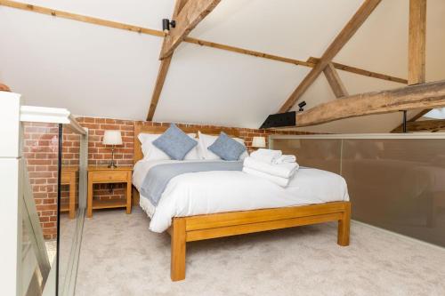 a bedroom with two beds in a room at The Hay Loft in Swafield