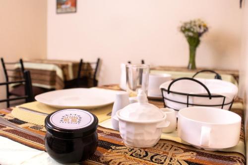 a table with plates and cups on a table at La Puerta Del Sol in Arequipa