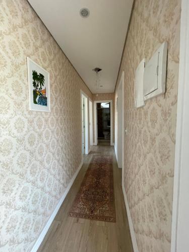 a hallway of a home with a carpet and wallpaper at Casa happy day in Angra dos Reis