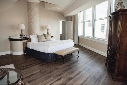 a bedroom with a large bed and a large window at Haywood Park Hotel, an Ascend Collection Hotel in Asheville