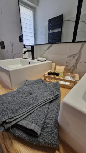 ein Badezimmer mit einem Waschbecken und einem Handtuch auf dem Boden in der Unterkunft Appartamento Oro in Mantello