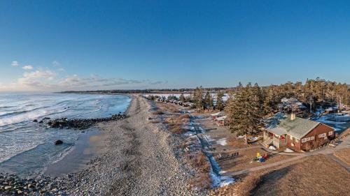 an aerial view of a beach with a house and the ocean at White Point Beach Resort in Summerville Centre