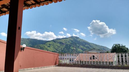 a view of a mountain from a building with a fence at Mi Casa Wi-Fi e Garagem Grátis Próx Praia do Recreio in Rio de Janeiro