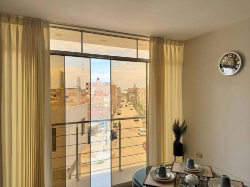 a room with a large window with a view of a city at Exclusivo departamento en Chiclayo in Chiclayo