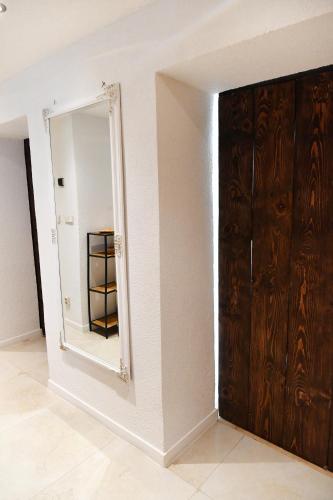 a mirror on a wall next to a closet at APARTMAN Tradicia in Michalovce