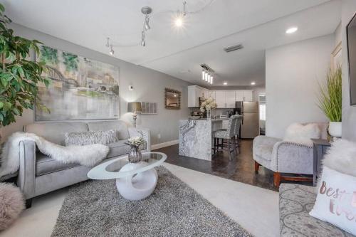 a living room with a couch and a table at Chic pad in center of Seminole Heights-322 in Tampa