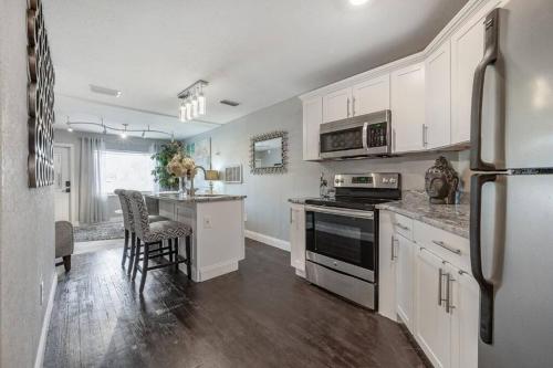 a kitchen with white cabinets and a stove top oven at Chic pad in center of Seminole Heights-322 in Tampa