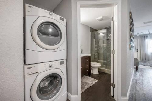 a washer and dryer in a bathroom with a toilet at Chic pad in center of Seminole Heights-322 in Tampa