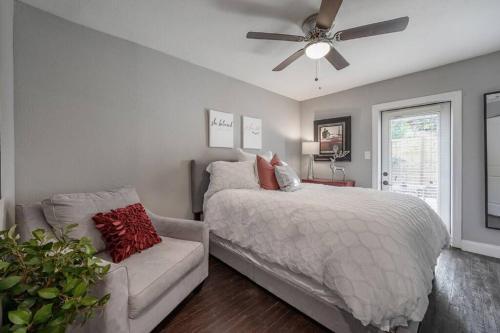 a bedroom with a bed and a couch and a ceiling fan at Chic pad in center of Seminole Heights-322 in Tampa