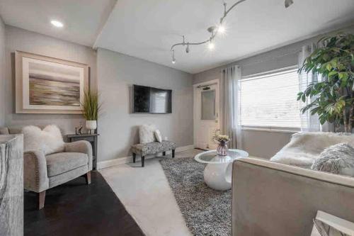 a living room with a couch and a chair at Chic pad in center of Seminole Heights-322 in Tampa
