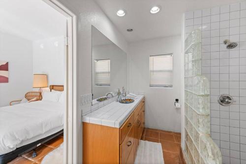 a bathroom with a bed and a sink and a shower at La Quinta Casita : Private Pool - Close to Old Town in La Quinta