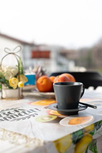 a cup of coffee sitting on a table with fruit at Terrazza baciata dal sole in Lazise