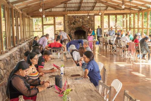 a group of people sitting at tables in a building at Posada San Lázaro in Choluteca